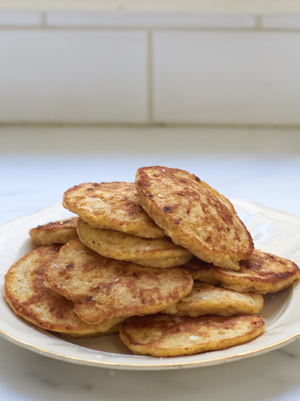 a stack of cottage cheese pancakes on a white plate