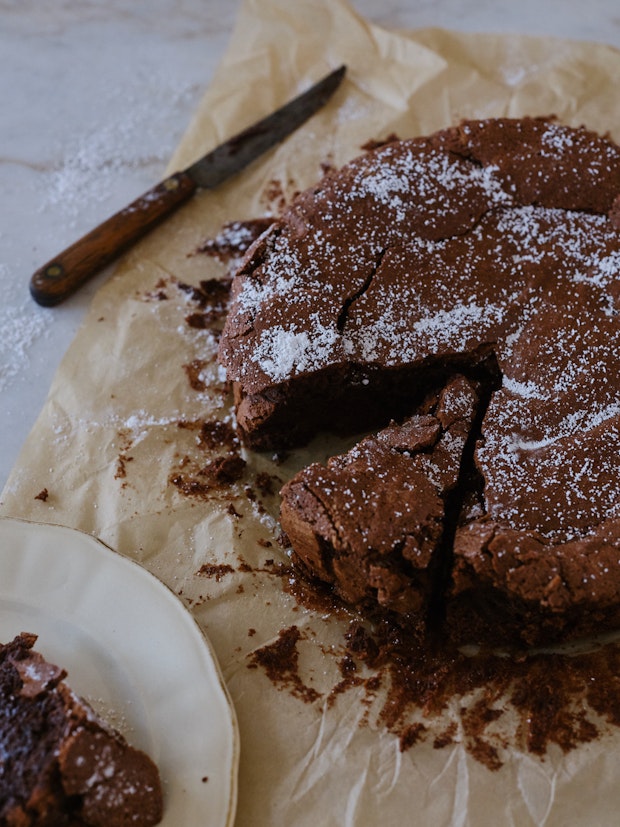 Close up photo of a Flourless Chocolate Cake next to a Knife