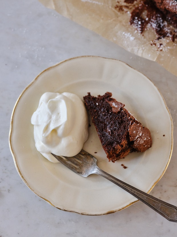 A Slice of Flourless Chocolate Cake on a Small White Plate