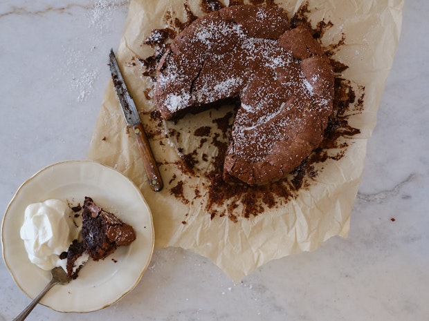 Close up photo of Flourless Chocolate Cake with a Slice Cut from It