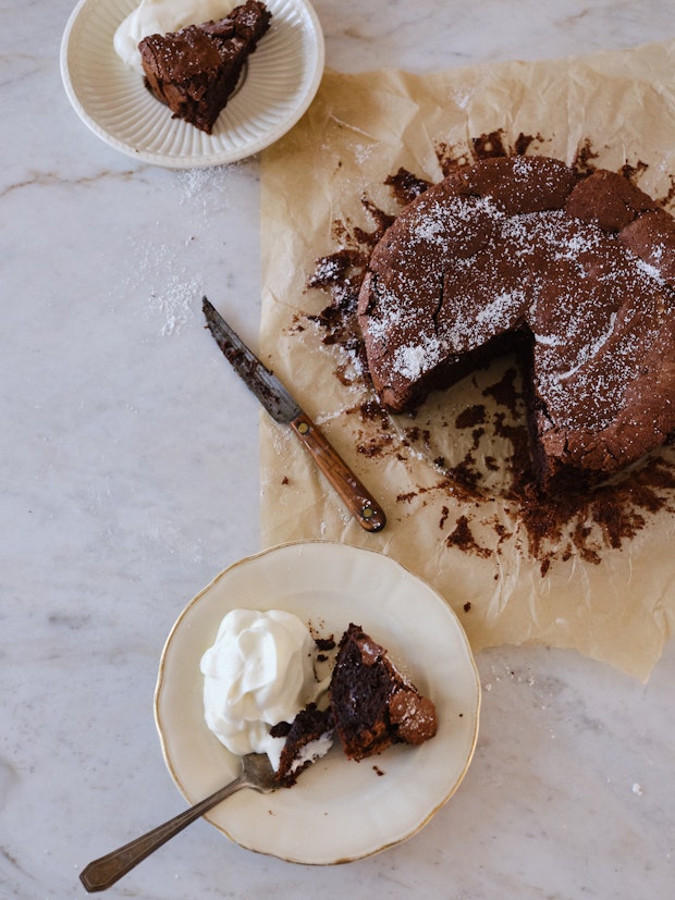 Marble Table with Flourless Chocolate Cake and Two Plates with Slices of Cake