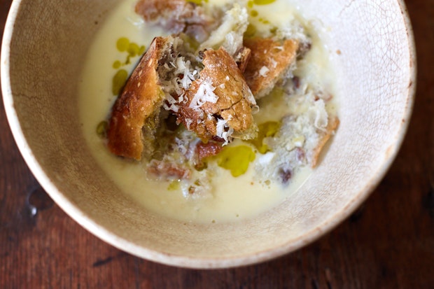 garlic soup in a bowl with toasted baguette