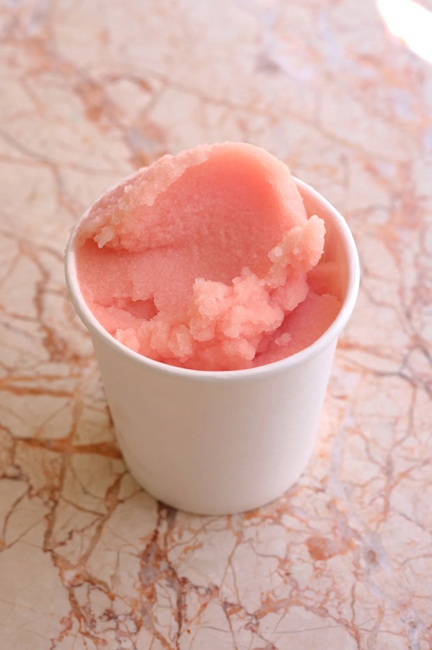 sorbet served in a white cup on a marble counter
