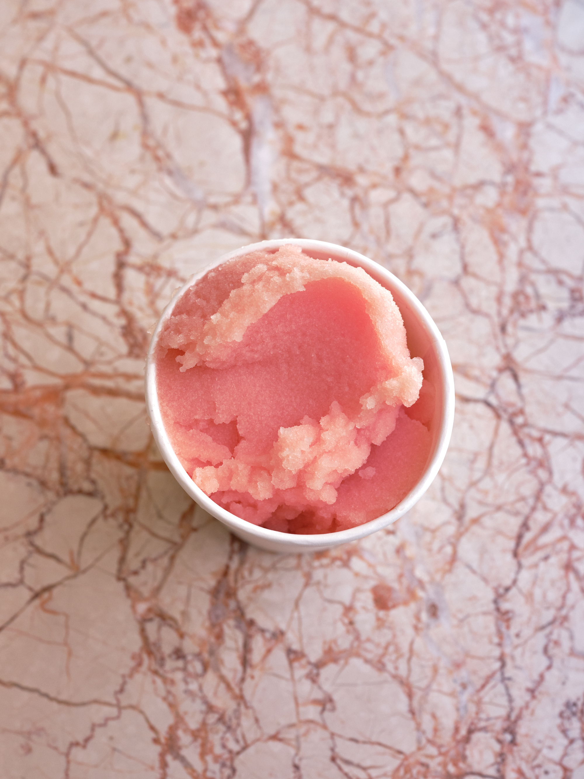 Grapefruit sorbet served in a white cup