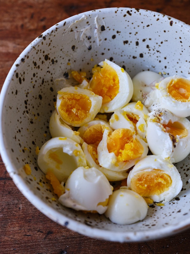 hard boiled eggs smashed in a bowl