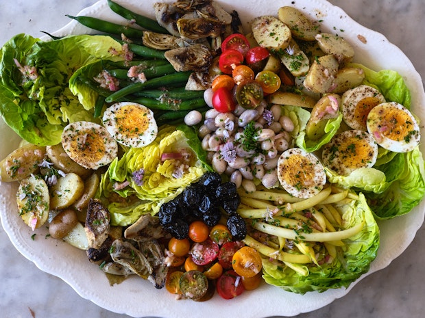 hard boiled eggs on a platter with other nicoise salad ingredients