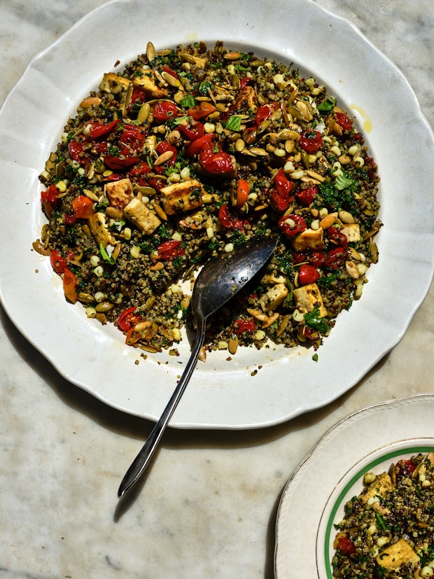 Big plate of quinoa with tomatoes, pesto, and pepitas