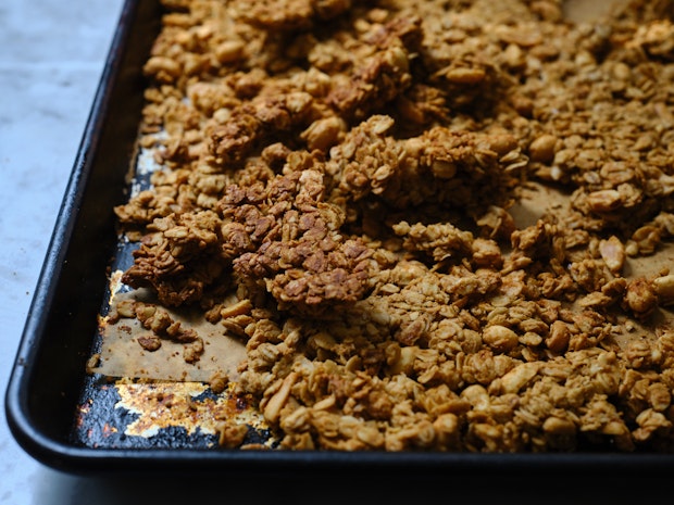 peanut butter granola cooling on a baking sheet