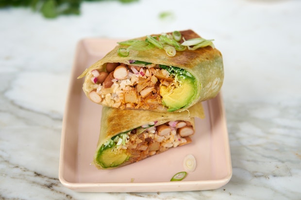 jackfruit carnitas inside a burrito on a plate