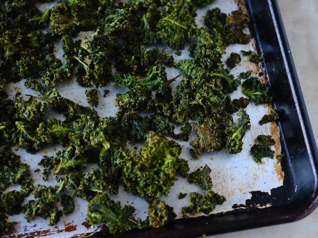 baked kale chips on a baking sheet after baking