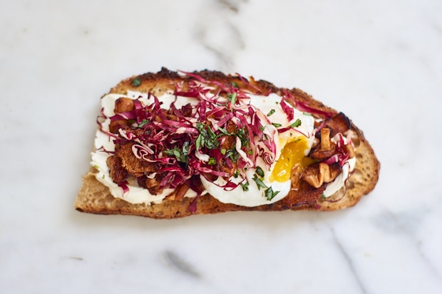 labneh smeared into a piece of sourdough and topped with an egg and other ingredients