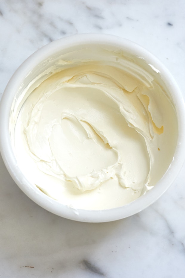 labneh in a white bowl on a marble countertop