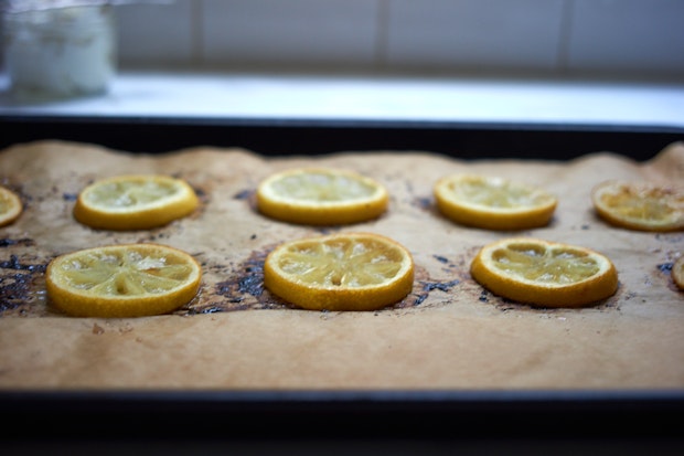 lemon slices arranged on a parchment lined baking sheet