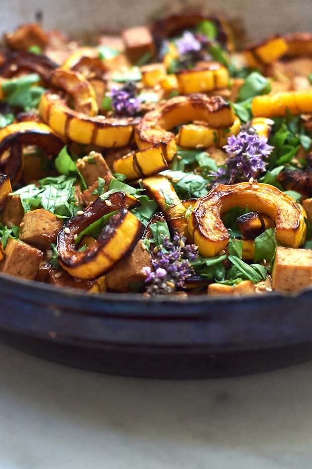 roasted delicata squash along with other ingredients in a large serving bowl