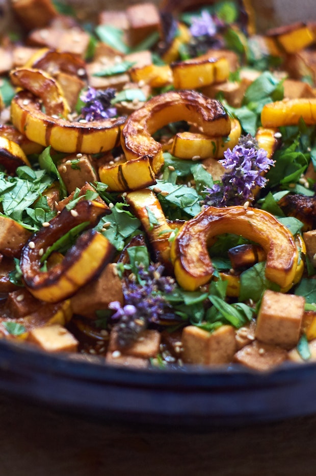 roasted delicata squash along with other ingredients in a large serving bowl