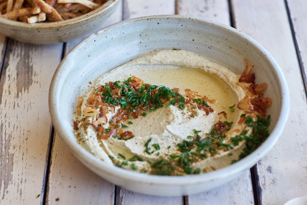 mung bean dip in a bowl with chives and shallot oil