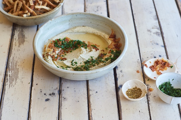 mung bean dip in a bowl with chives and shallot oil