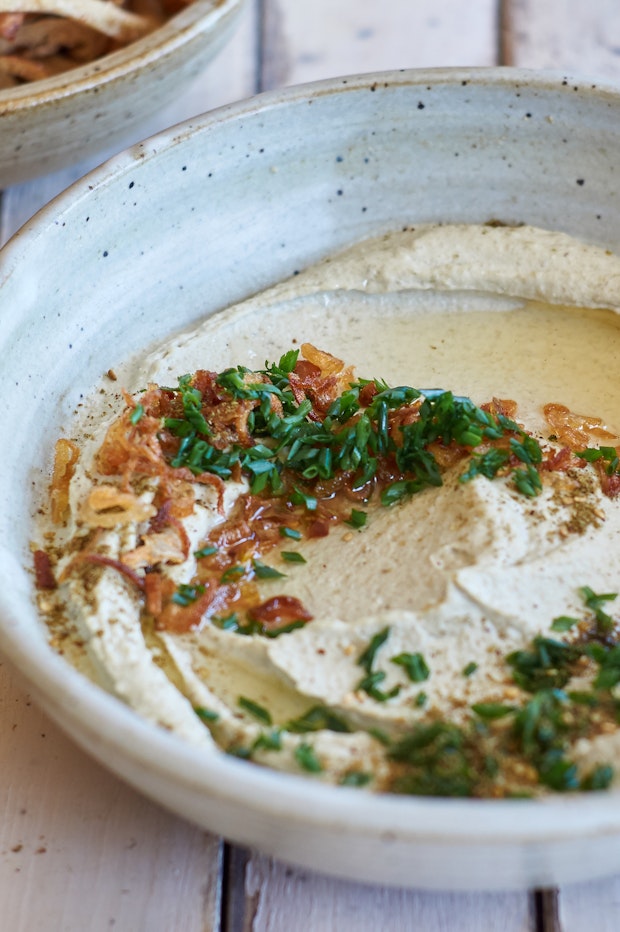 mung bean dip in a bowl with chives and shallot oil
