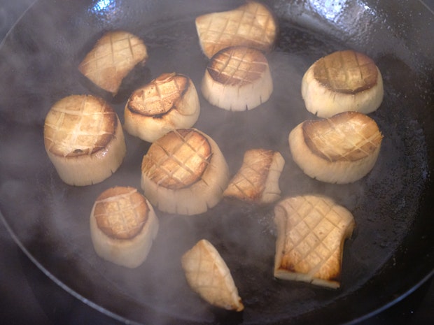 mushroom scallops cooking in a hot skillet