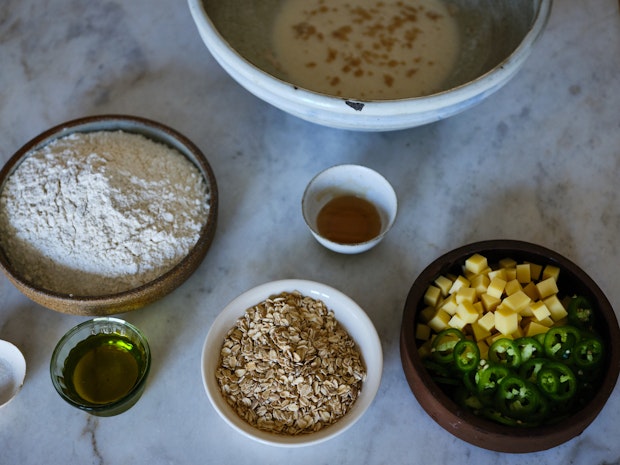 Ingredients to make Cheddar Jalapeño Oatmeal Bread on Marble Counter