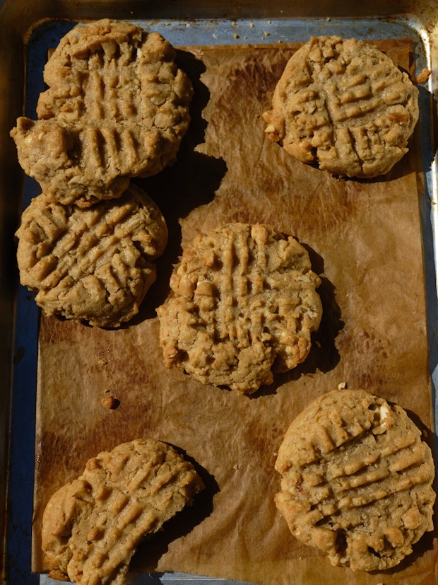 peanut butter cookies on a baking sheet lined with parchment paper
