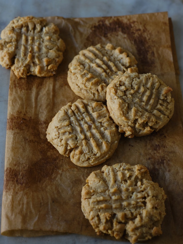 a peanut butter cookie on a baking sheet made with oatmeal