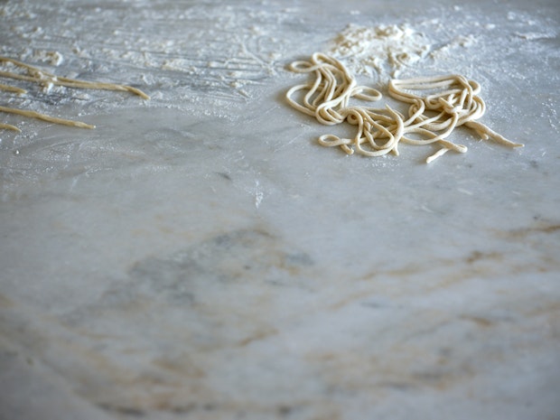 Pici tangled on a flour-dusted counter