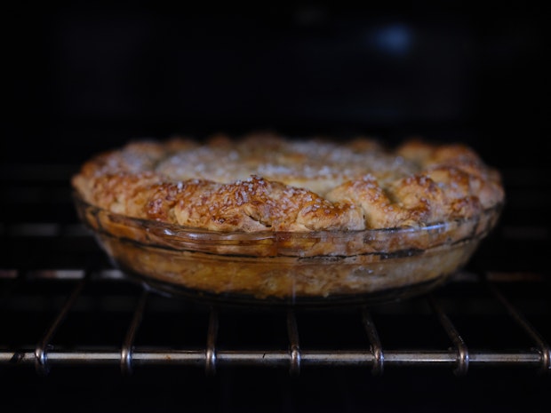 pie baking in oven with deeply golden crust