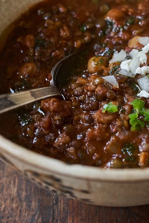 Vegetarian chili in a bowl with chopped onion on top