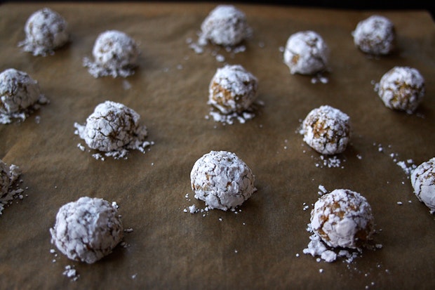 small balls of cookie dough arranged on a parchment-lined baking sheet