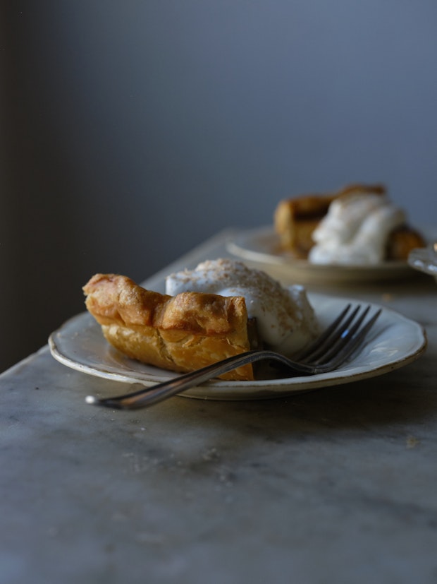 slice of pumpkin pie on a plate with a fork