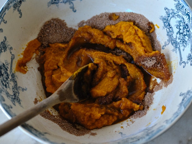 pumpkin puree, brown sugar, and spices being mixed in large bowl