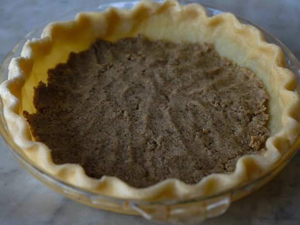 pie crust lined with hazelnut butter before baking