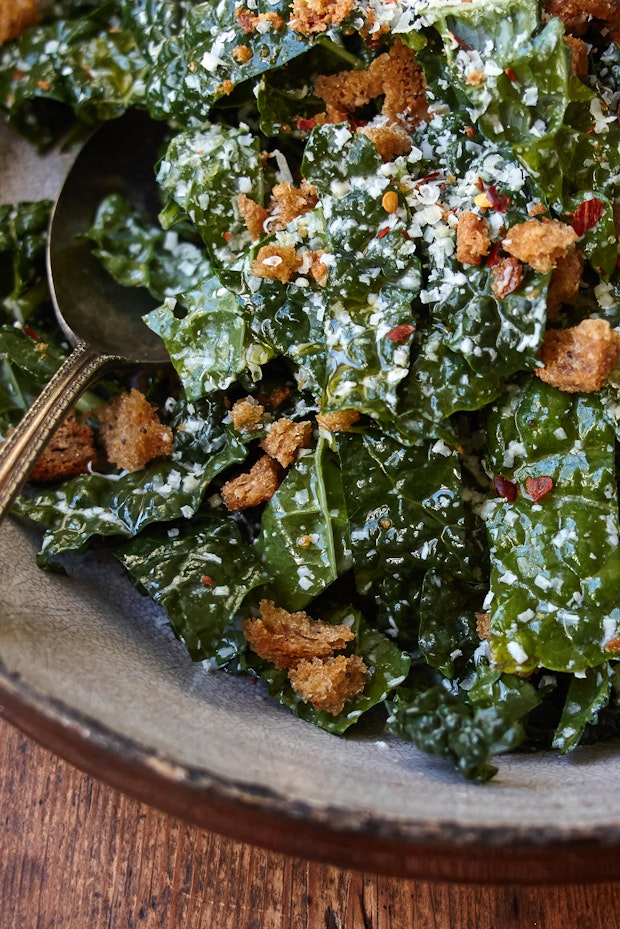 kale salad topped with breadcrumbs in a large bowl