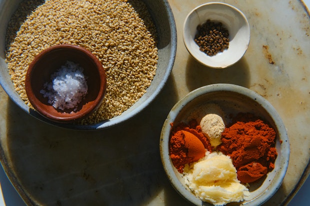 Ingredients to use in red gomashio including sesame seeds, cardamom, chile powders, brown sugar