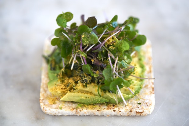 rice cracker topped with avocado and nutritional yeast