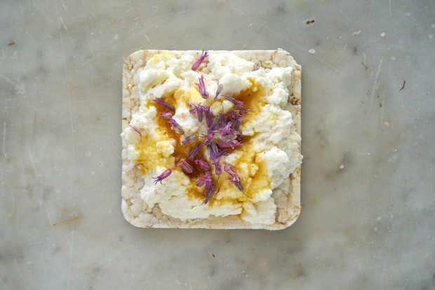 rice cracker topped with ricotta and honey