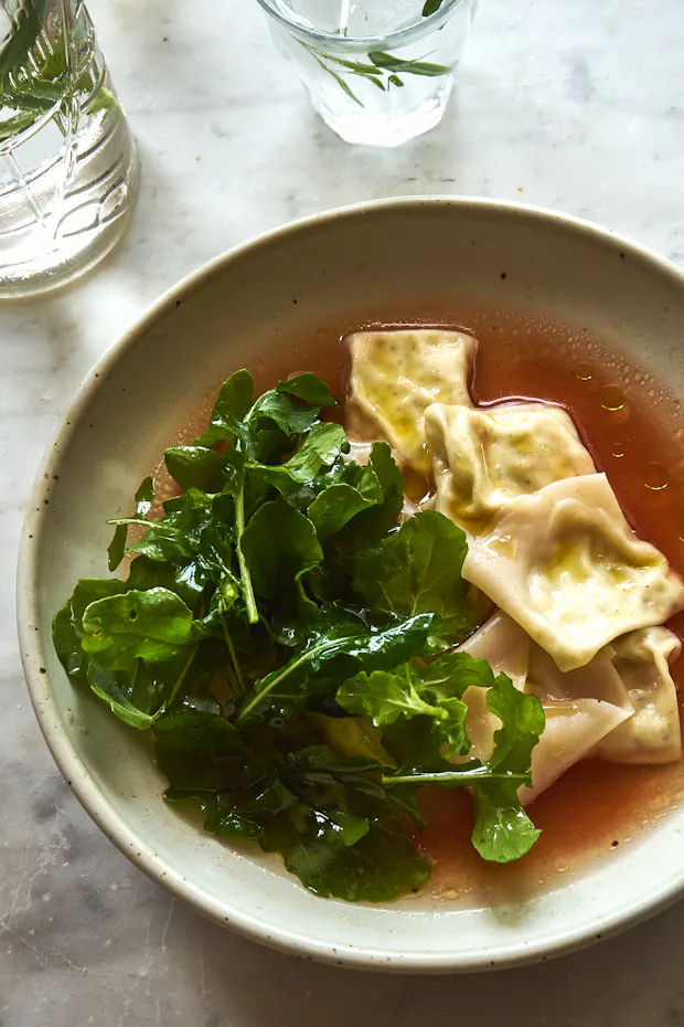 Ricotta dumplings in a tomato broth in a shallow bowl