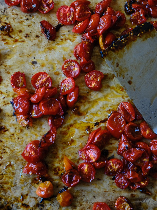 deeply roasted cherry tomatoes on a sheet pan