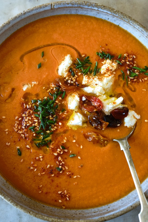 roasted tomato soup in a bowl with various toppings