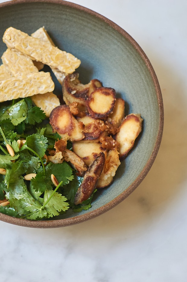 sake mushrooms in a bowl with a salad placed on a countertop