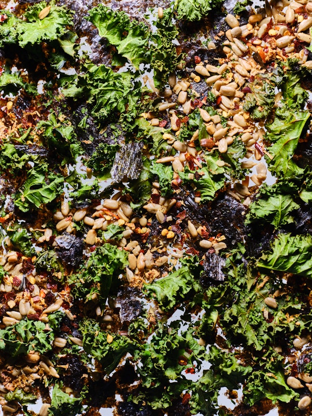 kale, seaweed, sunflowers and spices - ingredients to make salad booster