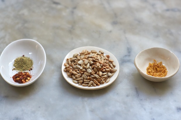 kale, seaweed, sunflowers and spices - ingredients to make salad booster