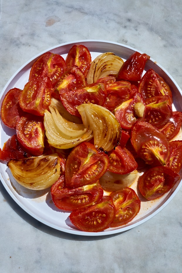 Tomatoes and onions on a plate after roasting.