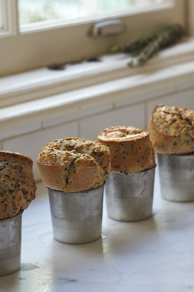 freshly baked seeded popovers cooling on a countertop