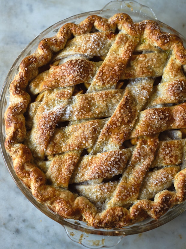 a beautiful apple pie with lattice crust in a glass pie dish