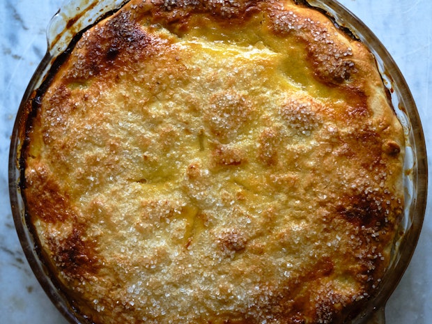 a shaker lemon pie with crust turned under in a glass dish