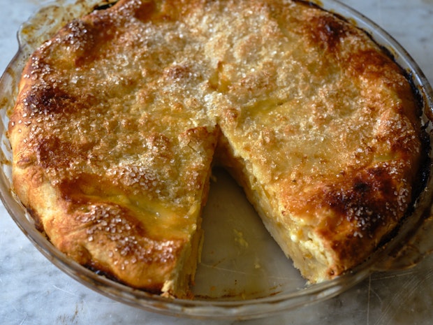 shaker lemon pie with a wedge cut out in a glass pie dish