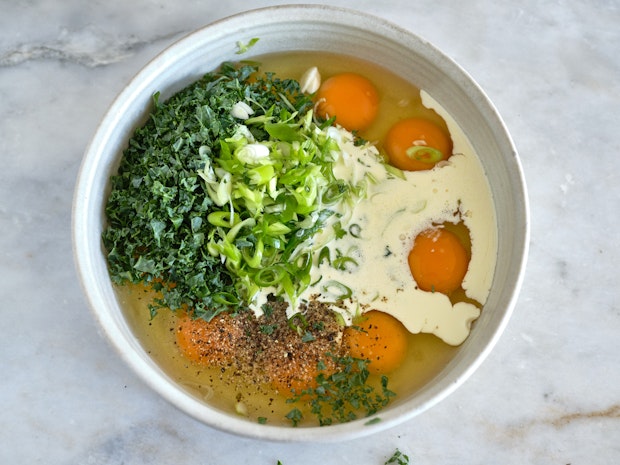 eggs, cream, and other ingredients in a white bowl