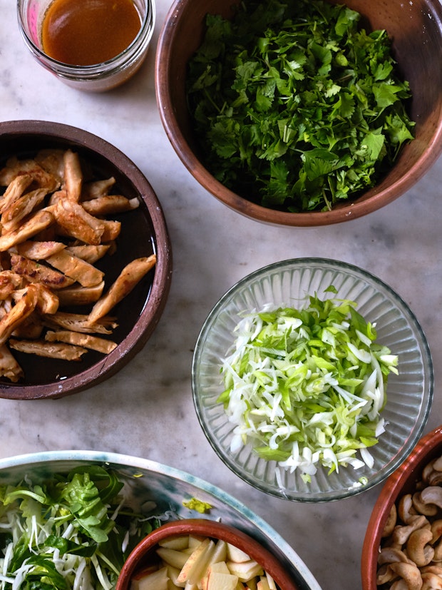 Ingredients for shredded chicken salad arranged on a countertop